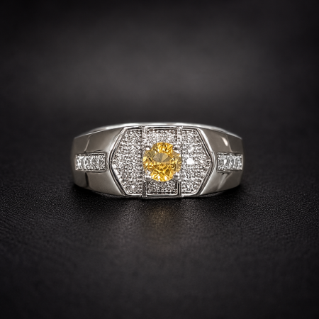 Silver ring with a yellow central gemstone surrounded by pave diamonds on a black background.