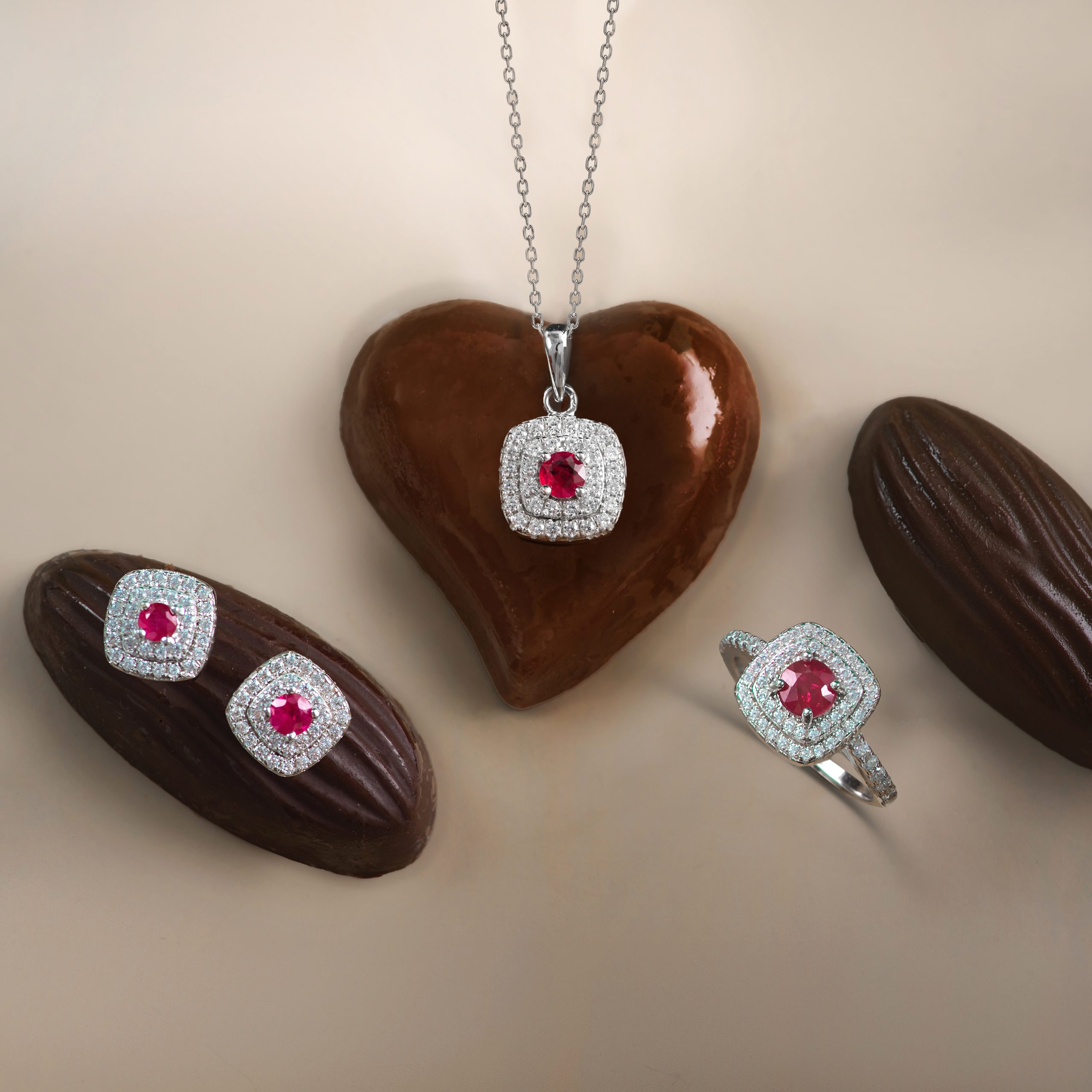 _NZR9777 Diamond-studded heart pendant on a silver chain resting on a chocolate heart.